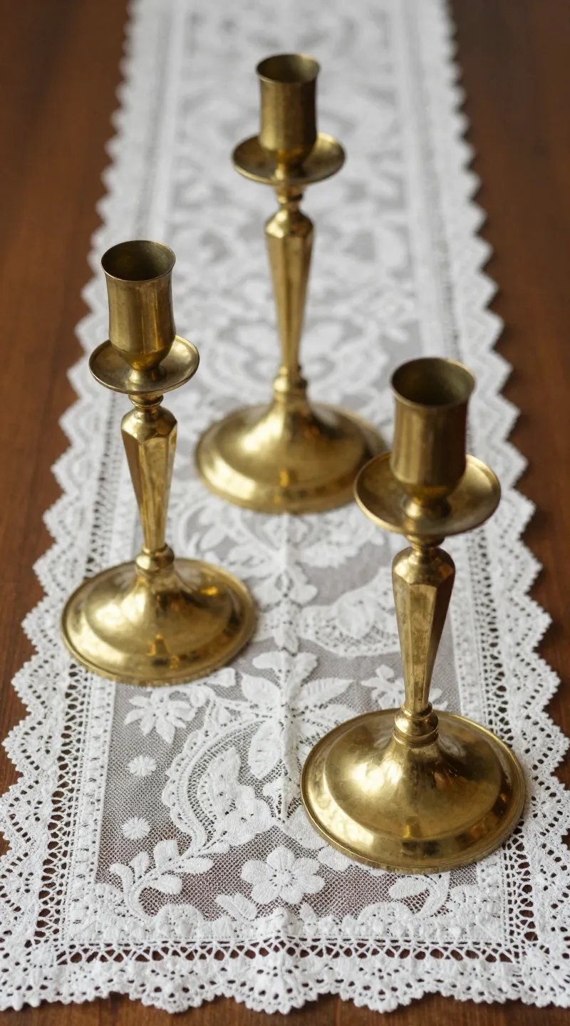 Brass candlesticks on vintage lace runner