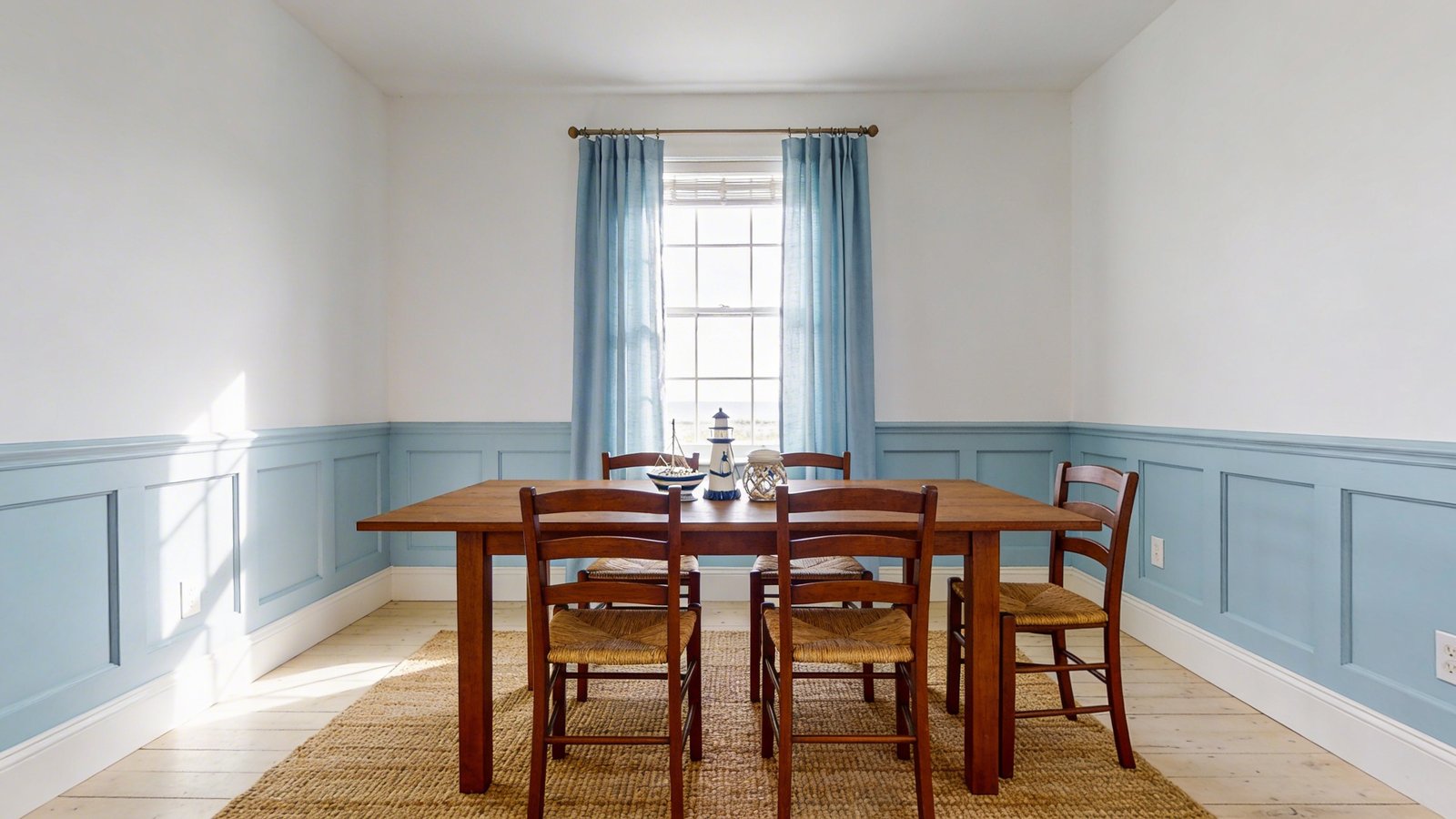 Coastal cottage dining room with pale blue wainscoting