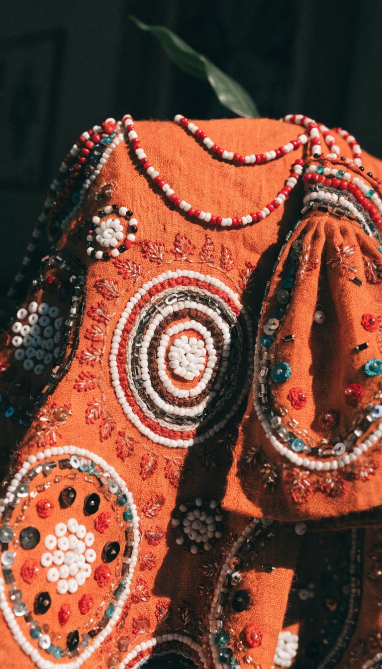 Burnt orange Moroccan textile with detailed embroidered patterns